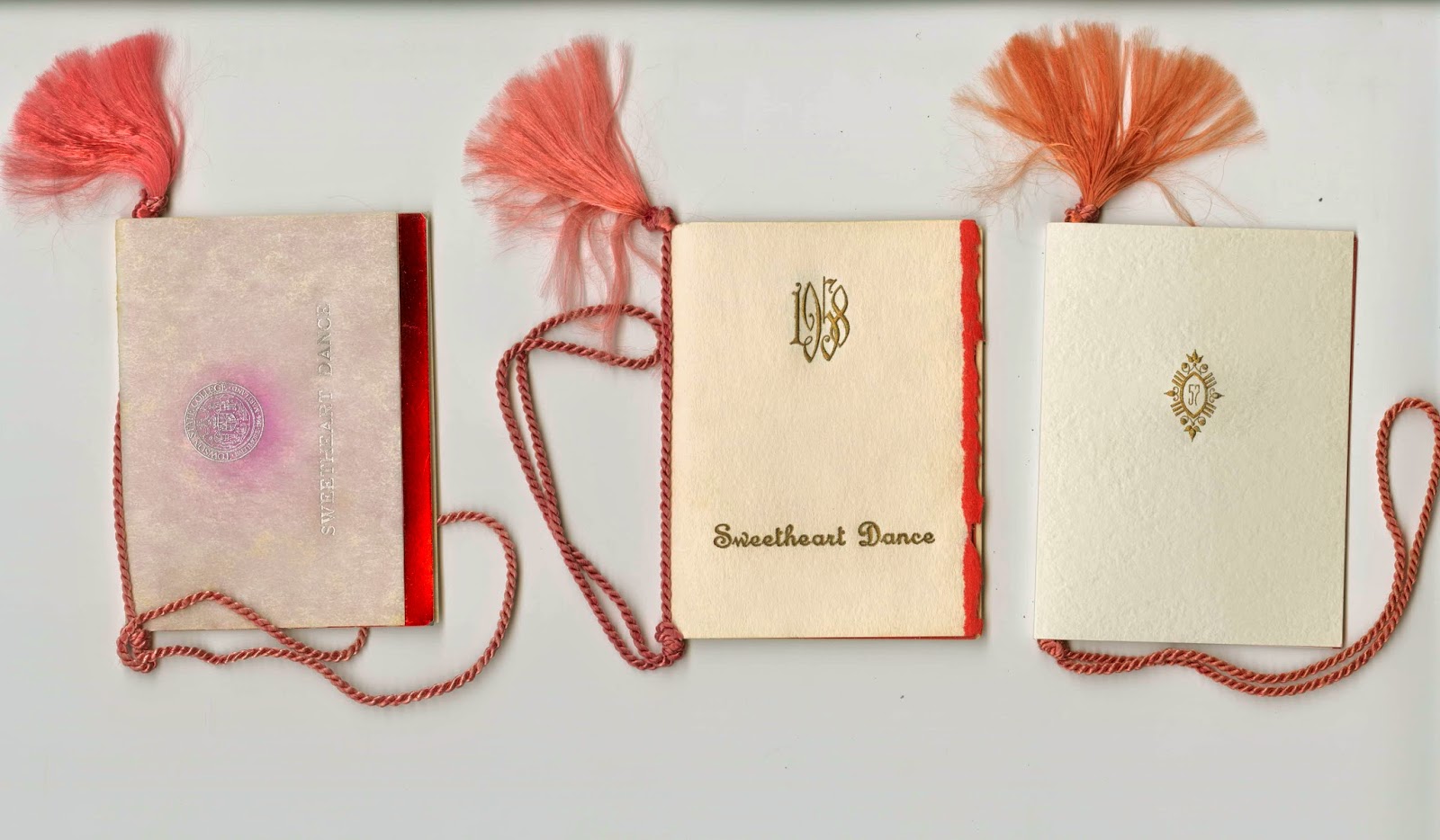 Three programs from the Sweetheart Dances, made with various white and red papers and red tassels.